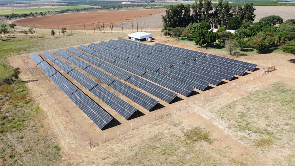 Solar panels on field with power lines